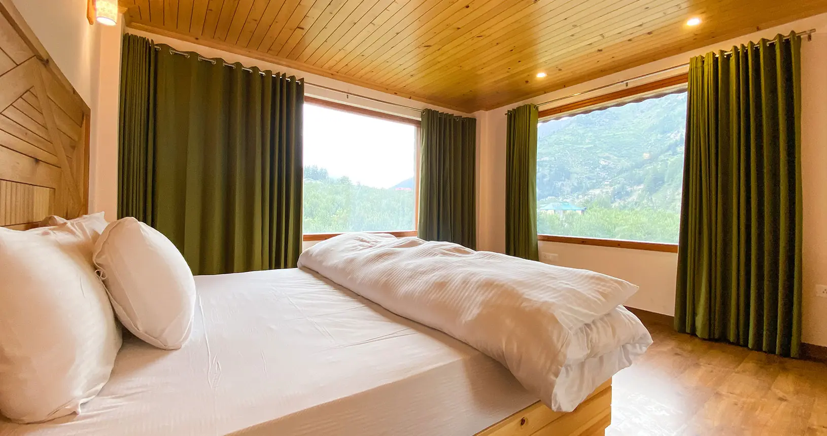 Bed and view from the family suite at Hotel Batseri, Sangla.